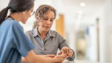 Doctor and patient work with smartphone